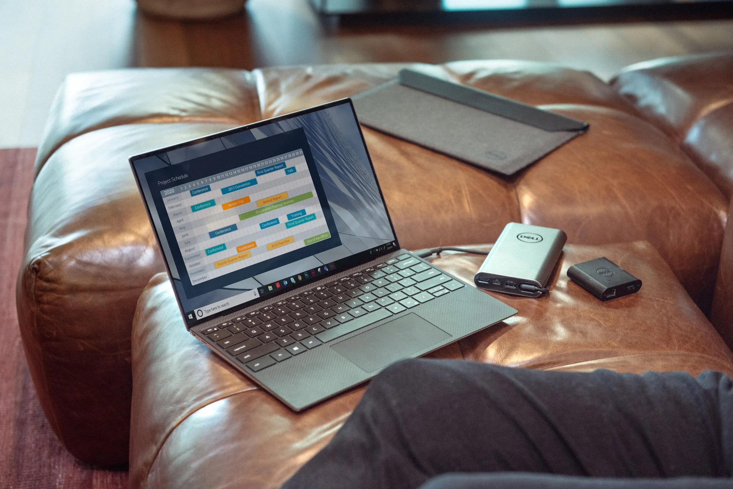 Laptop showing a product roadmap on a leather sofa
